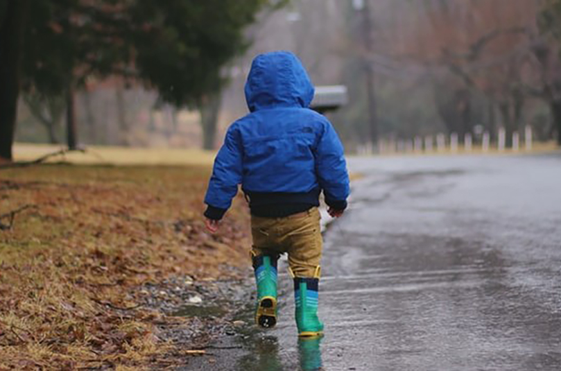 Toddler walking in the rain 